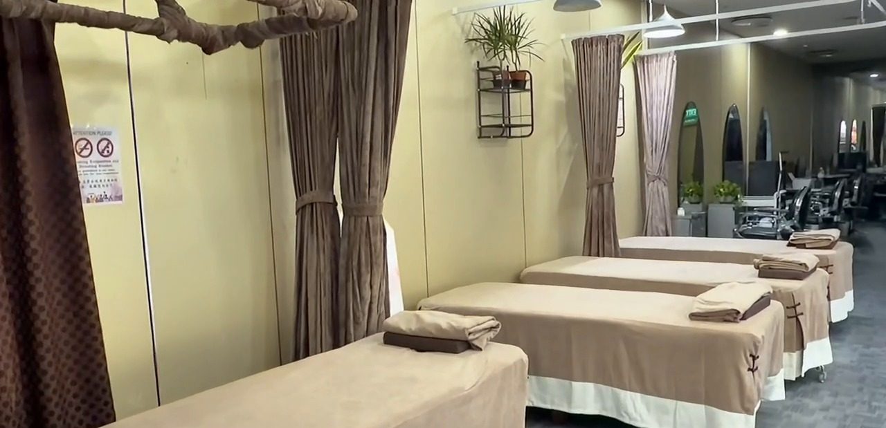 Row of massage beds with fresh towels