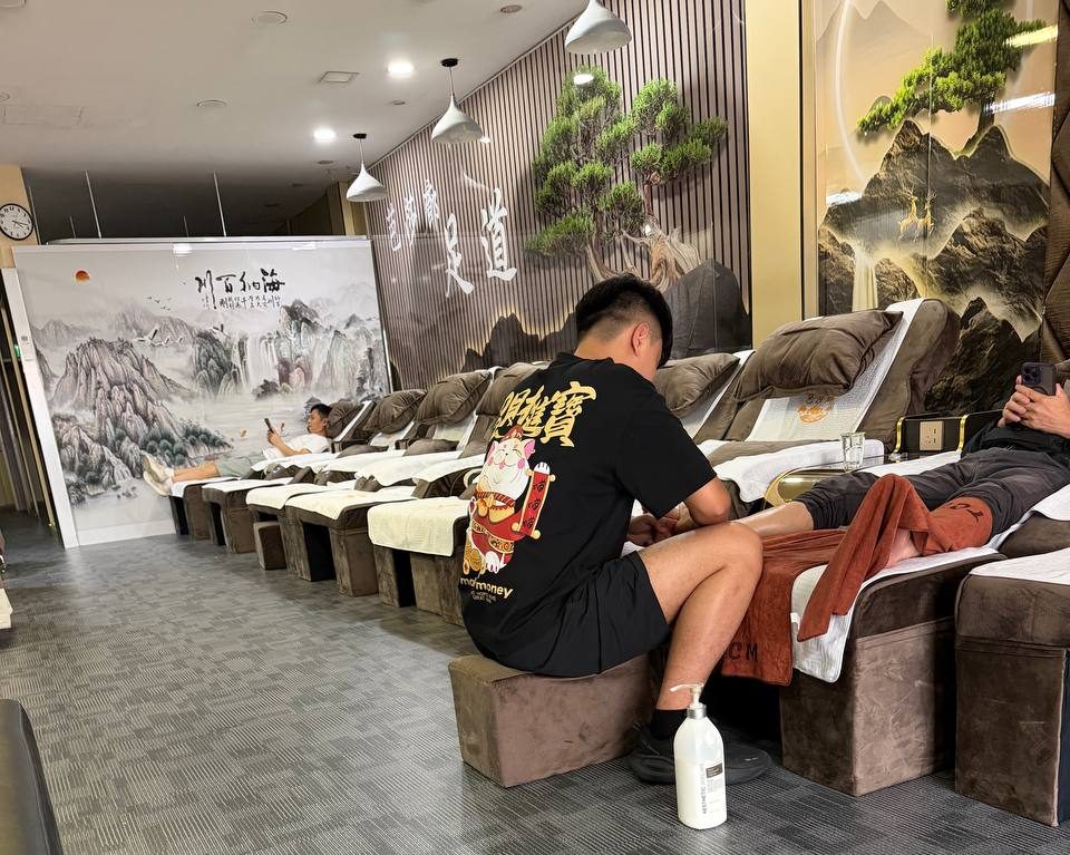 Reflexology lounge with rows of recliners and the 足道 wall